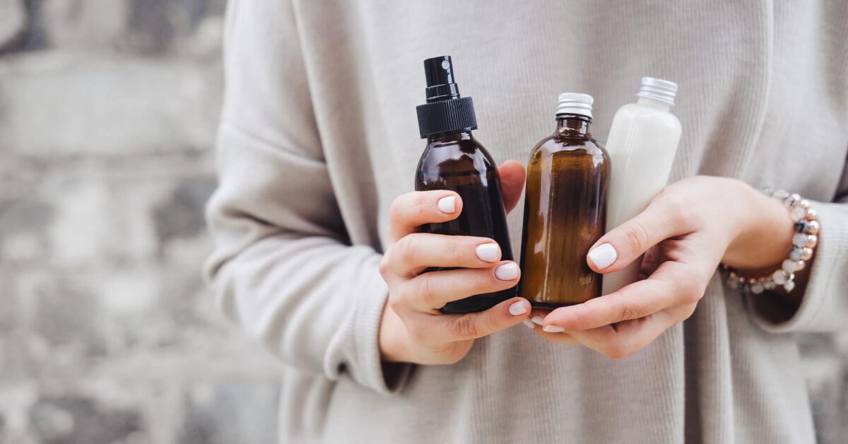 a hand holding a glass of orange juice