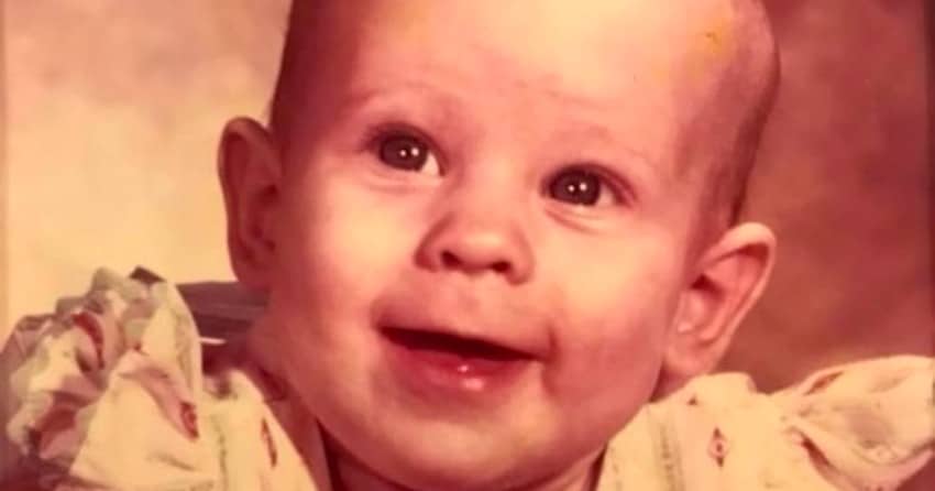 a little girl smiling at the camera