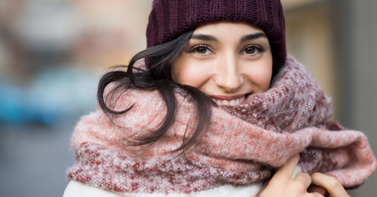 A woman bundled up for winter is glad that botox injections keep her skin smooth.