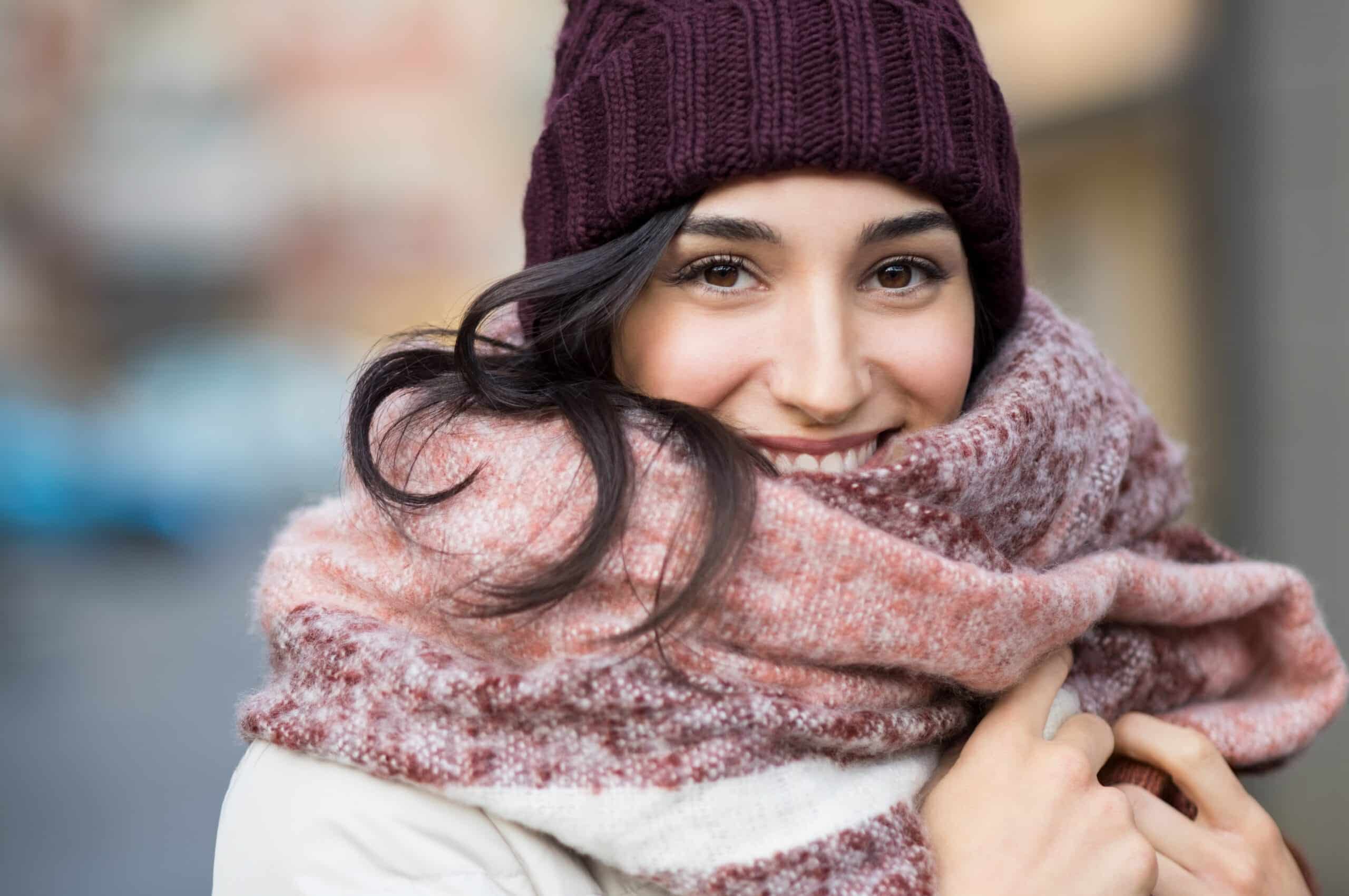 A woman bundled up for winter is glad that botox injections keep her skin smooth.