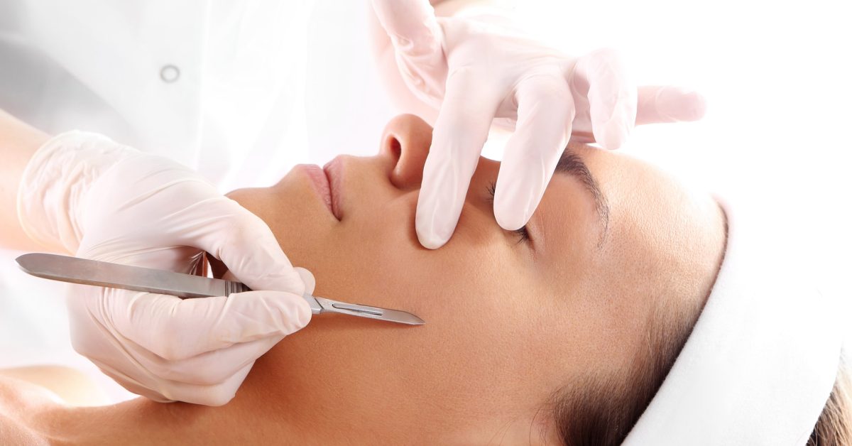 A woman undergoes a gentle and safe dermaplaning treatment at the expert hands of a trained aesthetics professional.