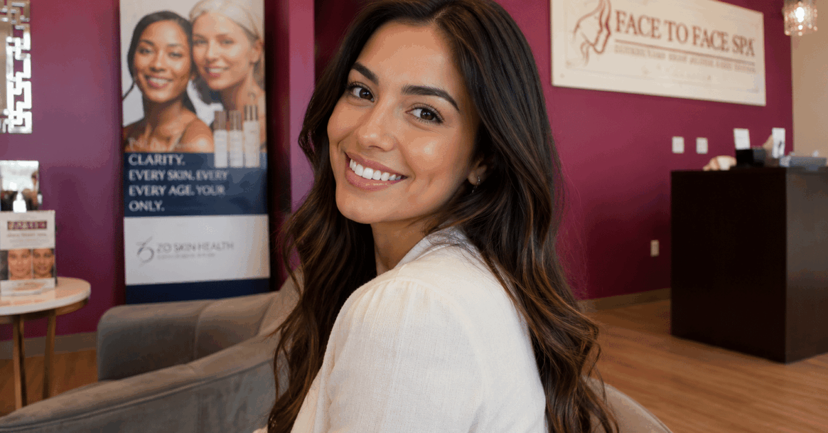 Smiling woman inside Face to Face Spa.